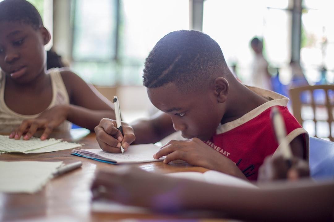 Boy writing on printer paper near girl from Santi Vedrí on Unsplash Bác sĩ giải đáp “chuyện ấy” - 1