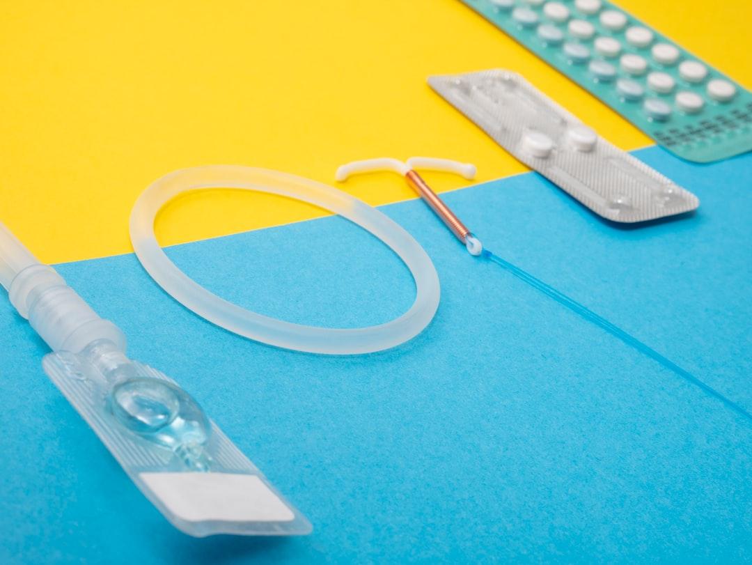 A medical device is laying on a blue and yellow surface from Reproductive Health Supplies Coalition on Unsplash