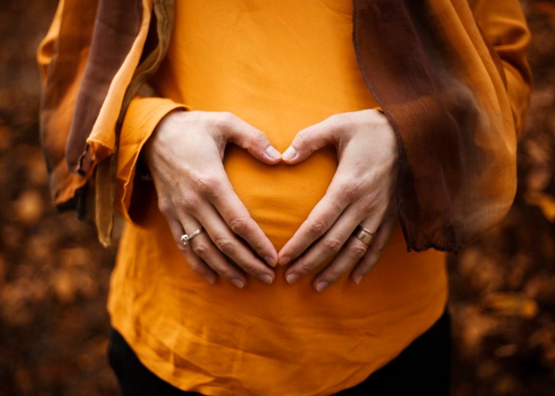 Person touching stomach from Alicia Petresc on Unsplash