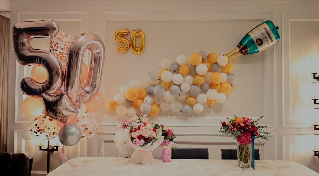 Yellow and white balloons on table from Lucas Law on Unsplash