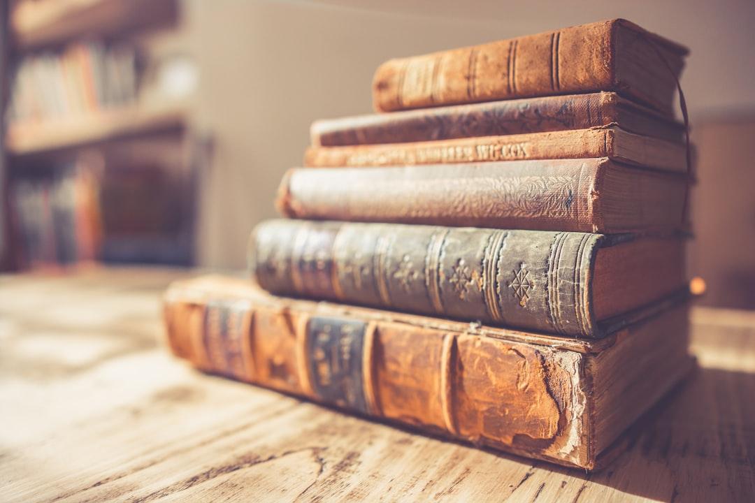 Stack of six brown hardbound books from Chris Lawton on Unsplash