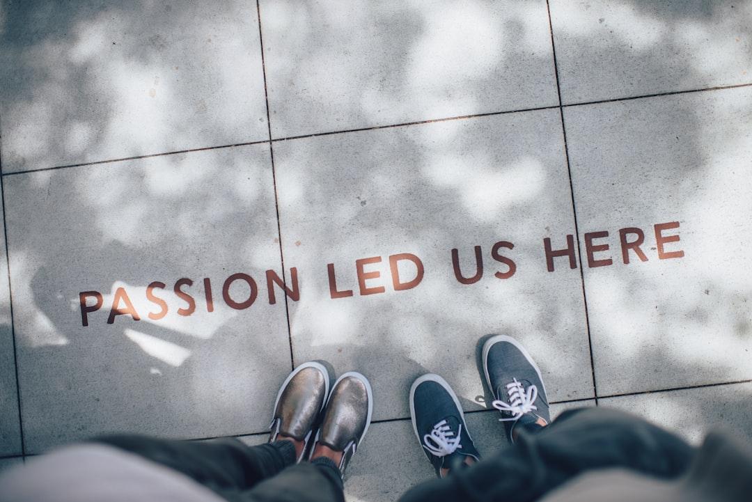 Two person standing on gray tile paving from Ian Schneider on Unsplash