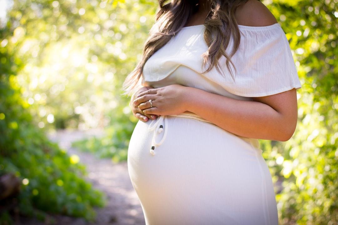 Pregnant woman standing near green plants from Ryan Franco on Unsplash