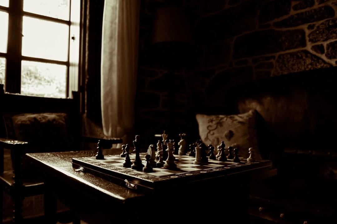 Chessboard on table beside window from Javier Grixo on Unsplash