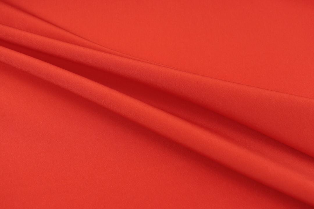 Red textile in close up photography from Divazus Fabric Store on Unsplash
