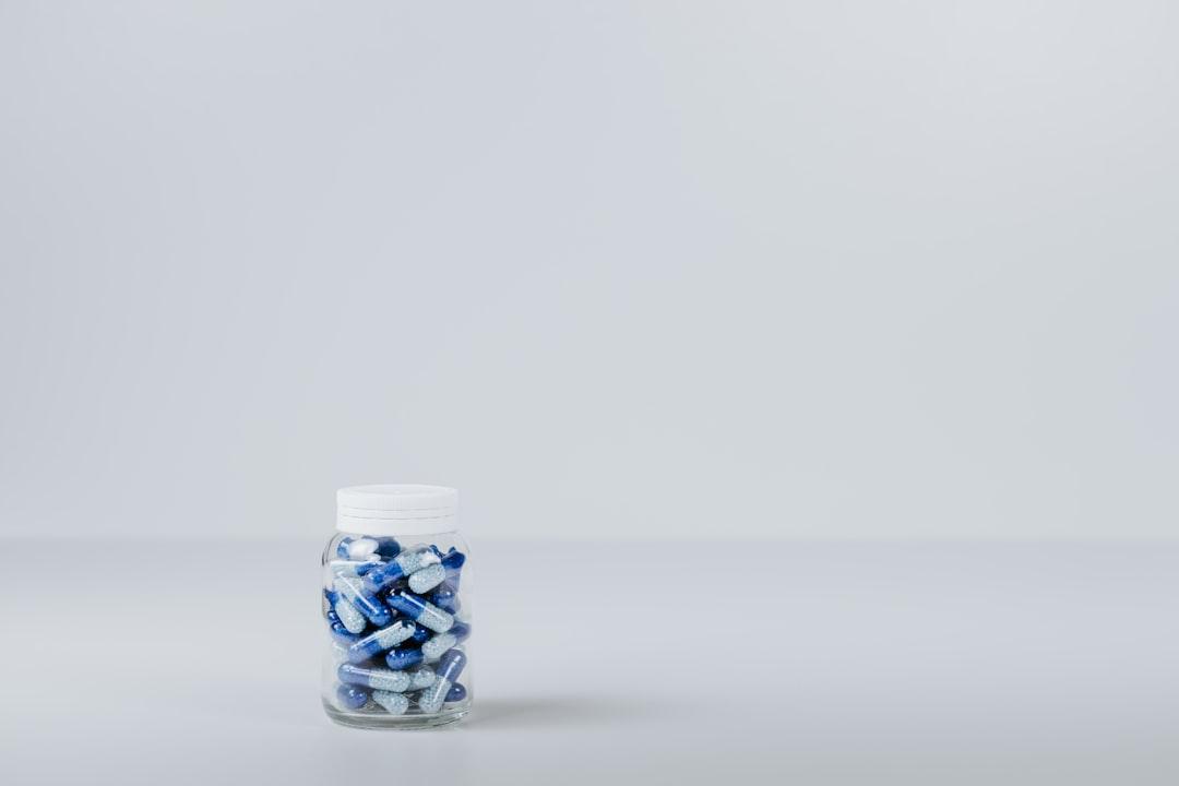 Blue and white tablet in container from Pawel Czerwinski on Unsplash