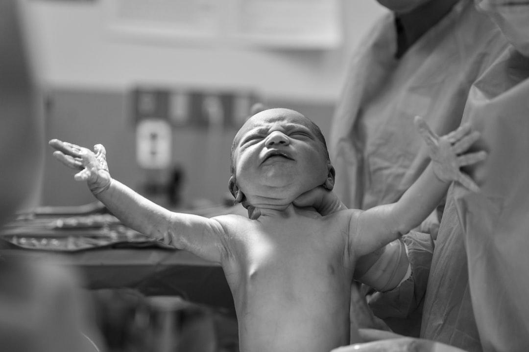 Grayscale photography of a new born baby from Alex Hockett on Unsplash
