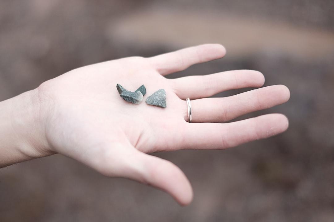 Three gray pebbles on person's palm from Felipe Elioenay on Unsplash TPHCM: Dịch bệnh tăng đột biến