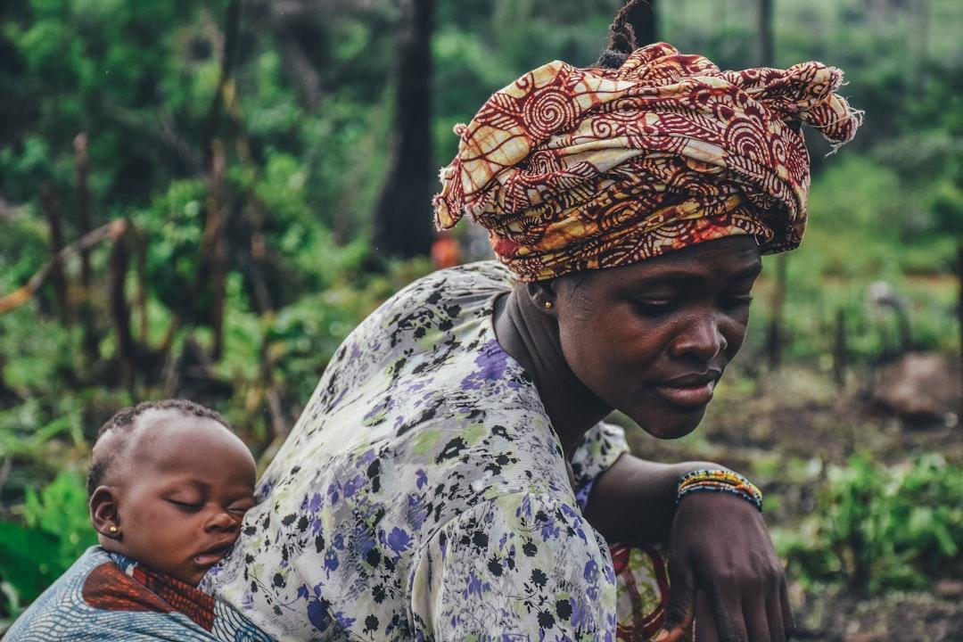 Woman carrying baby on back from Annie Spratt on Unsplash