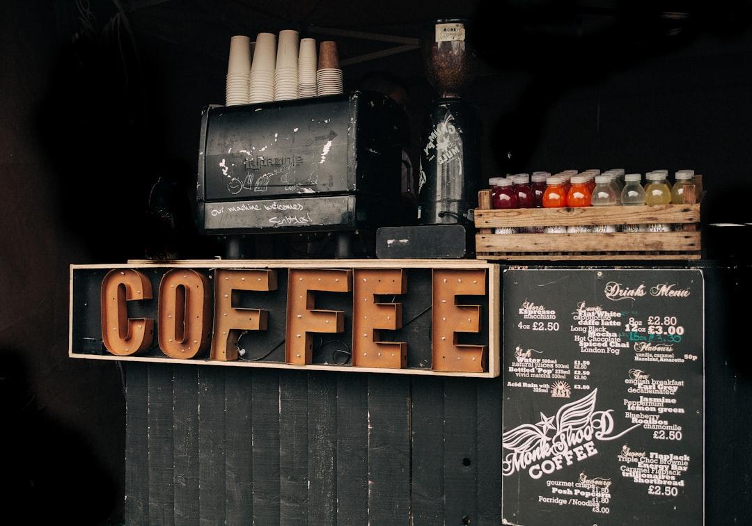 Brown coffee signage beside poster from Clem Onojeghuo on Unsplash Uống cà phê có thể kéo dài cuộc sống