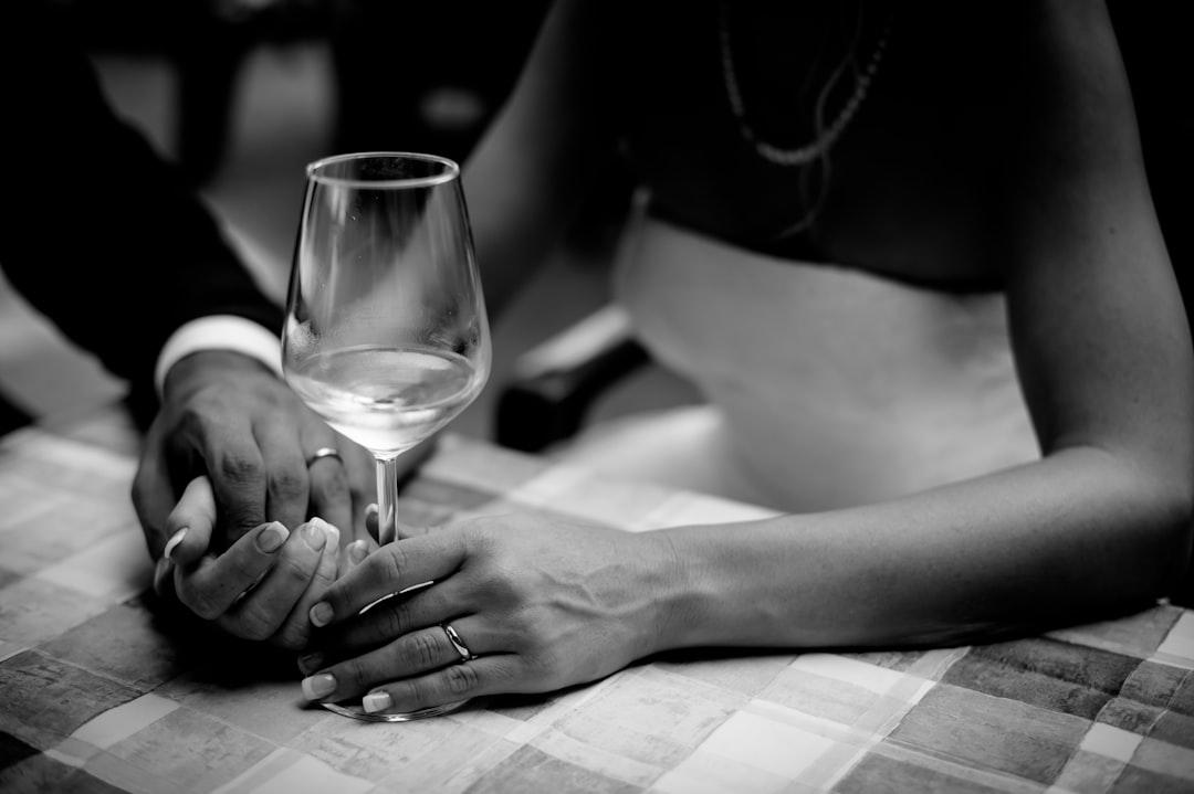 Grayscale photo of man holding hand of woman holding wine glass from Alfonso Lorenzetto on Unsplash Hết phải "chinh phục", chàng "bất mãn"...
