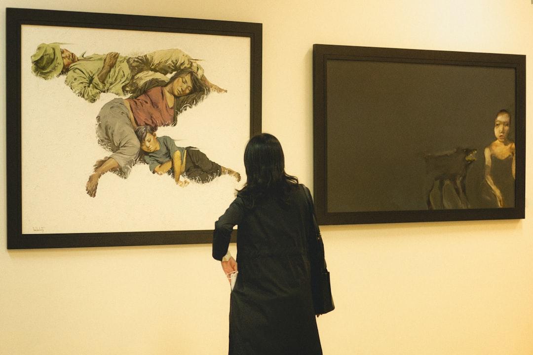 A woman standing in front of two paintings from buian_photos on Unsplash Khai trương Trung tâm Truyền máu khu vực Hà Nội