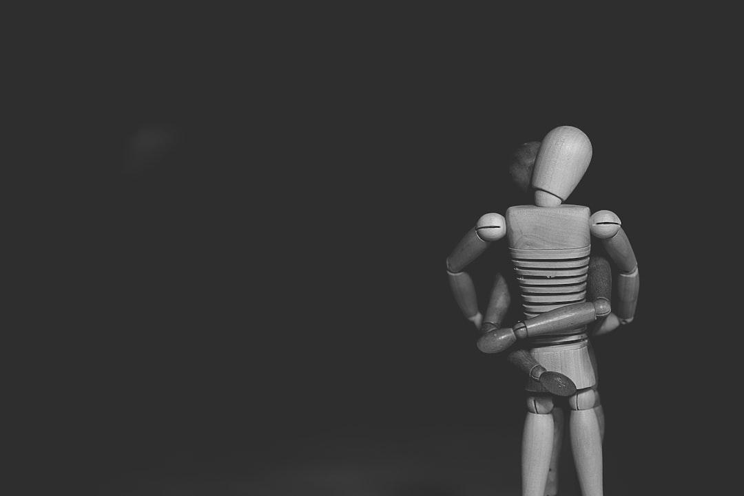 Grayscale photo of joint action figure hugging one another from Gaelle Marcel on Unsplash Chảy máu sau khi “yêu”