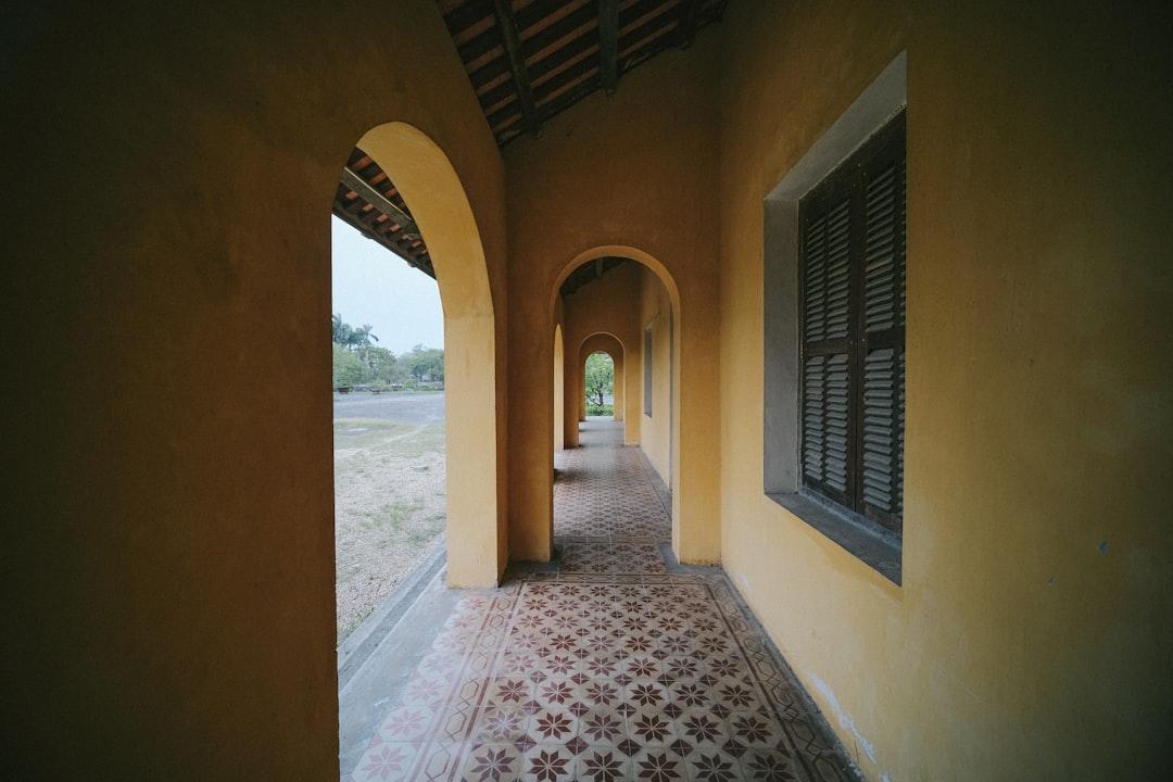 A long hallway with a tiled floor and arched windows from Pew Nguyen on Unsplash HIV/AIDS lây qua quan hệ tình dục tăng