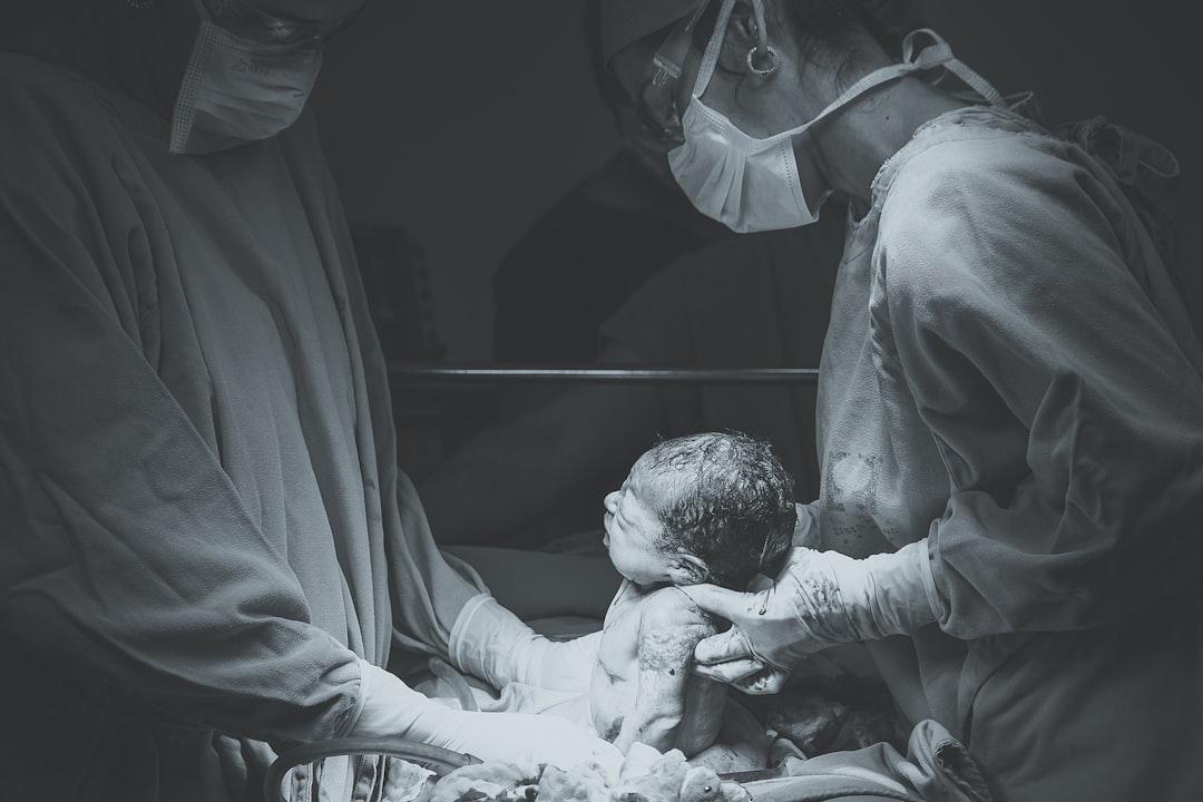 Greyscale photo of medical operation from Patricia Prudente on Unsplash 6 sai lầm khi chăm sóc bé sơ sinh