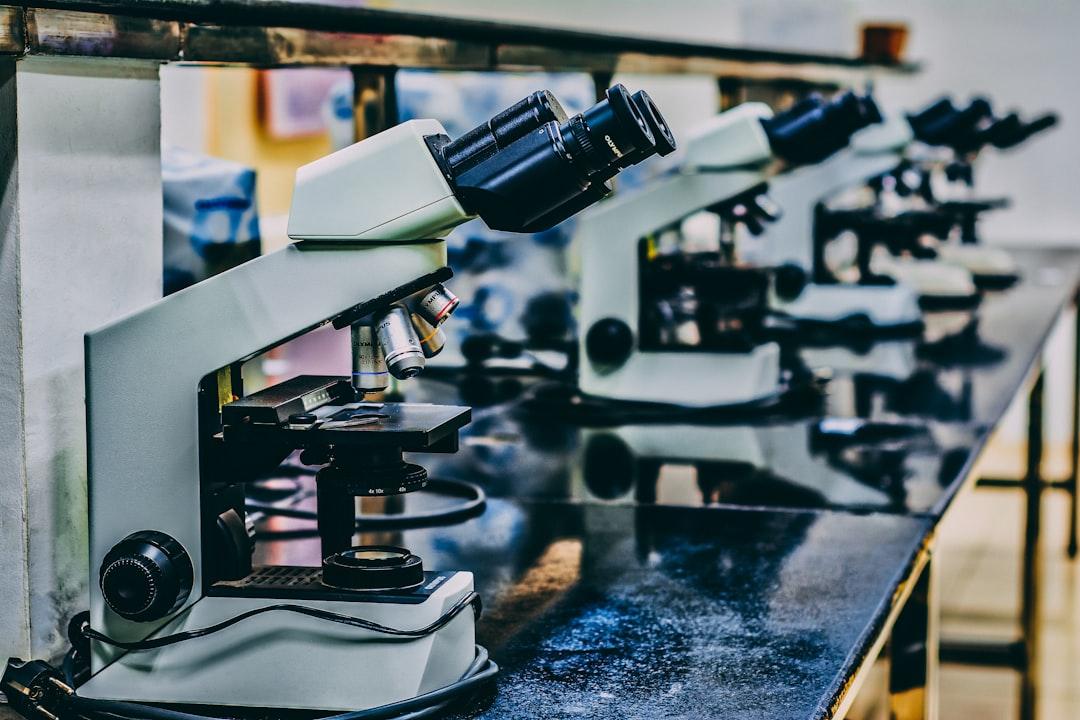 White microscope on top of black table from Ousa Chea on Unsplash Chế độ ăn quá béo gây giảm trí nhớ và lười biếng