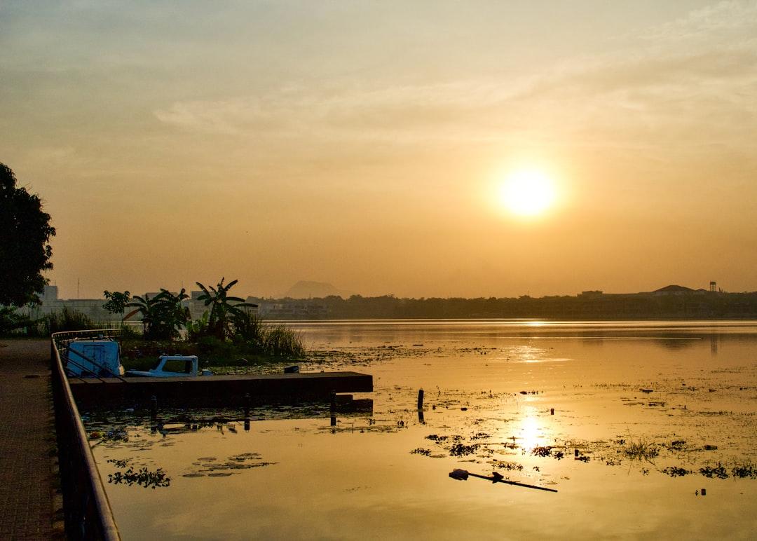 The sun is setting over a body of water from Solomon Wada on Unsplash Nigeria khuyến khích người có HIV lấy nhau