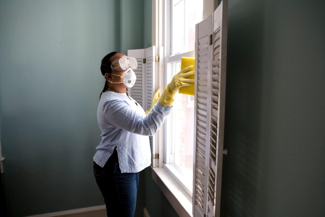 Woman in white long sleeve shirt and blue denim jeans standing beside white wooden framed glass from CDC on Unsplash Tái xuất ổ dịch cúm A/H1N1 mới, 3 bệnh nhân tử vong