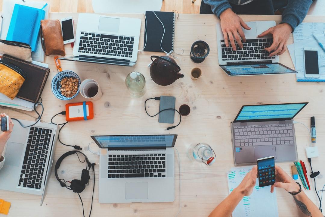 People sitting down near table with assorted laptop computers from Marvin Meyer on Unsplash