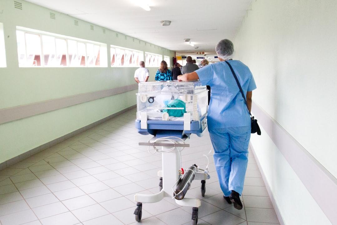 Person walking on hallway in blue scrub suit near incubator from Hush Naidoo Jade Photography on Unsplash 20 năm ăn bằng hông