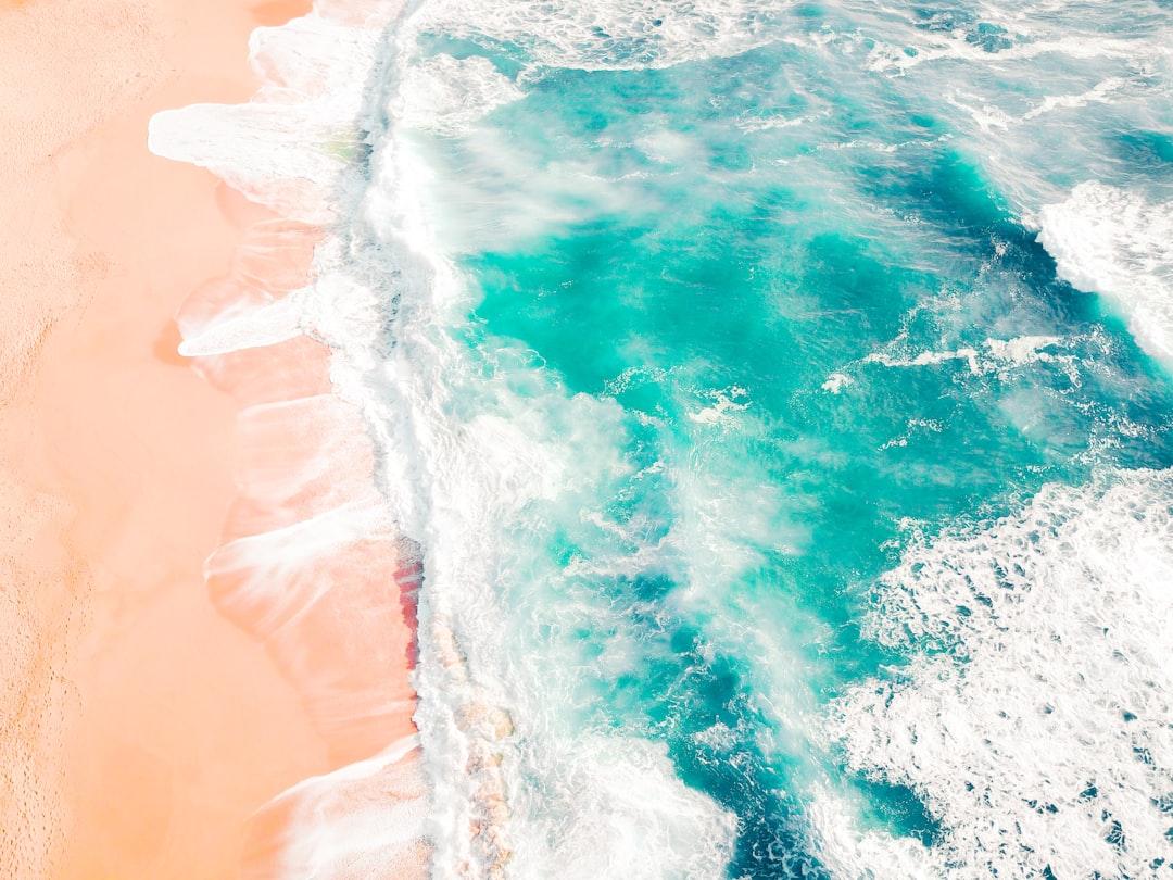 Bird's eye view of ocean waves from Sasha • Make Stories Studio on Unsplash