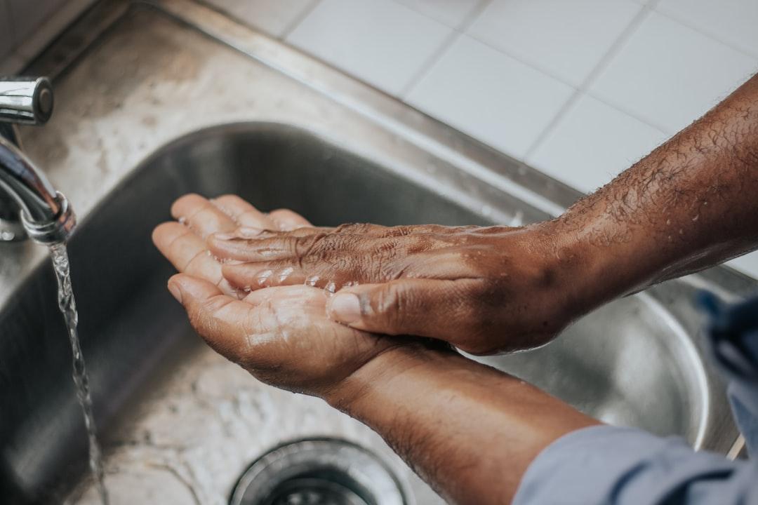 A person washing their hands in a sink from Mélissa Jeanty on Unsplash Muỗi bùng phát ở Bình Thạnh: Phun thuốc cũng như không