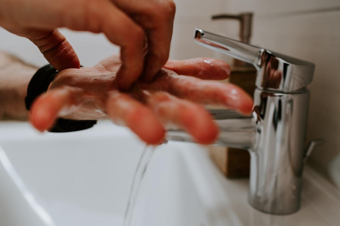 Washing hands with soap from Claudio Schwarz on Unsplash