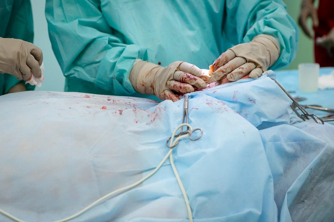 Person in operation gown holding scissors from Olga Kononenko on Unsplash Phẫu thuật dị tật khe hở môi, vòm miệng miễn phí cho 40 trẻ