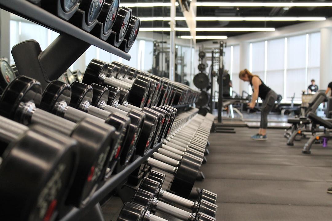 Woman standing surrounded by exercise equipment from Danielle Cerullo on Unsplash