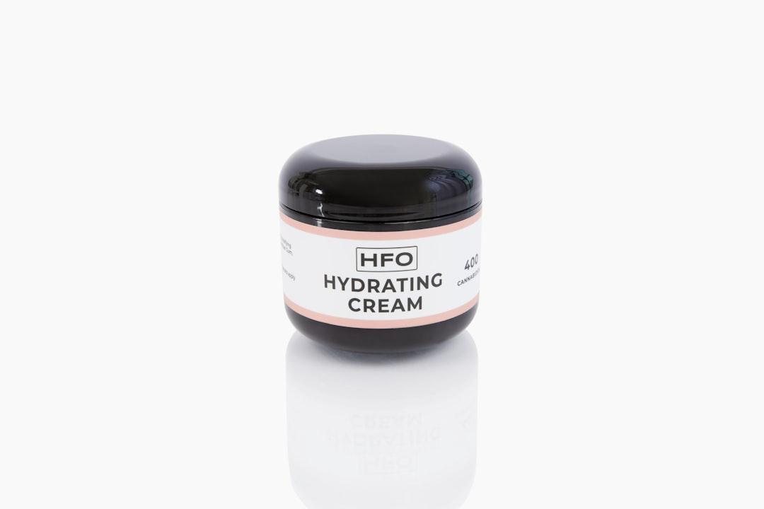A jar of hfo hydrating cream on a white background from Hemp Factory Outlet on Unsplash