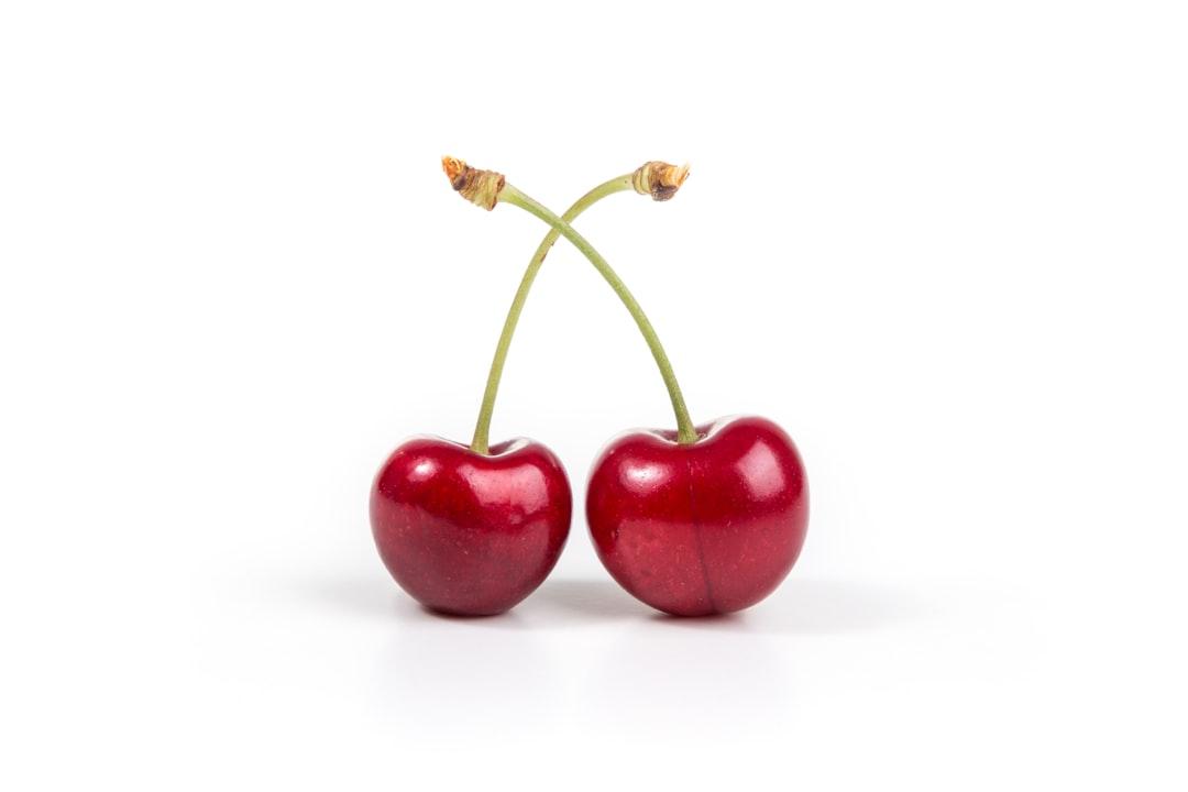 Two cherries on white surface from Quaritsch Photography on Unsplash