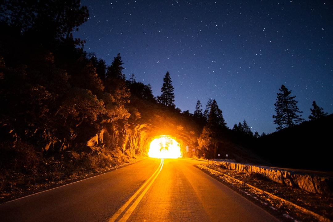 Photo of concrete pavement heading tunnel from Nathan Dumlao on Unsplash