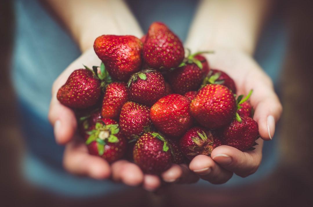Shallow focus photography of strawberries on person's palm from Arturrro on Unsplash