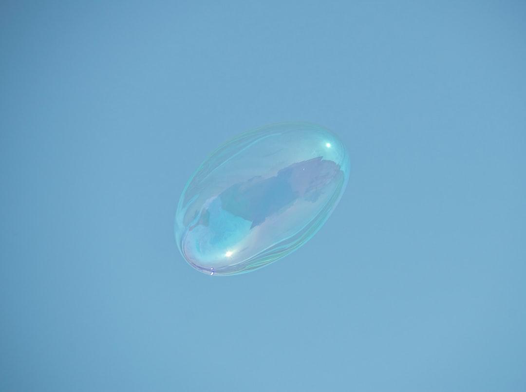 A soap bubble floating in the air on a clear day from aboodi vesakaran on Unsplash