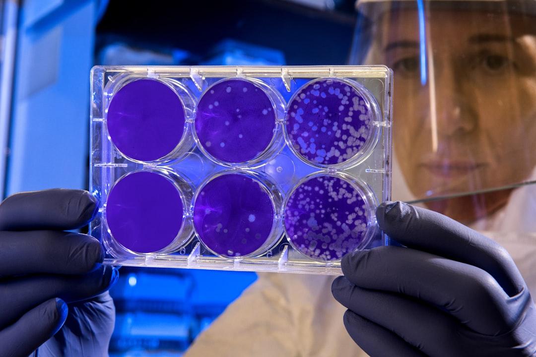 Woman holding laboratory appratus from CDC on Unsplash