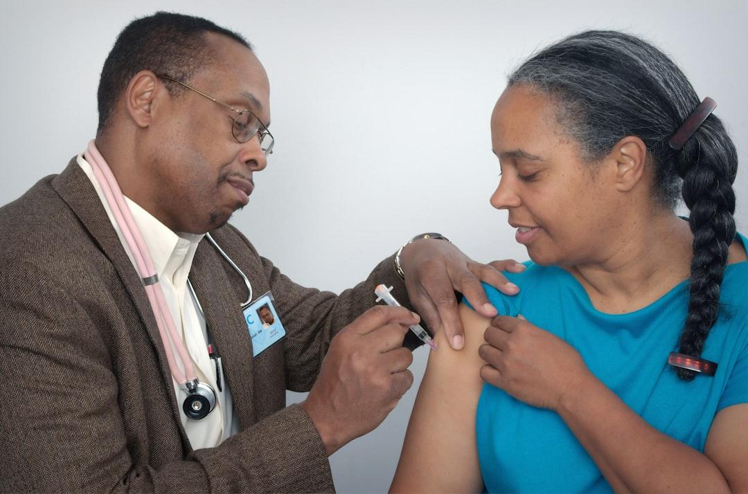 Man doing syringe on woman wearing blue shirt from CDC on Unsplash Ca bệnh tả đầu tiên tại Tây Ninh
