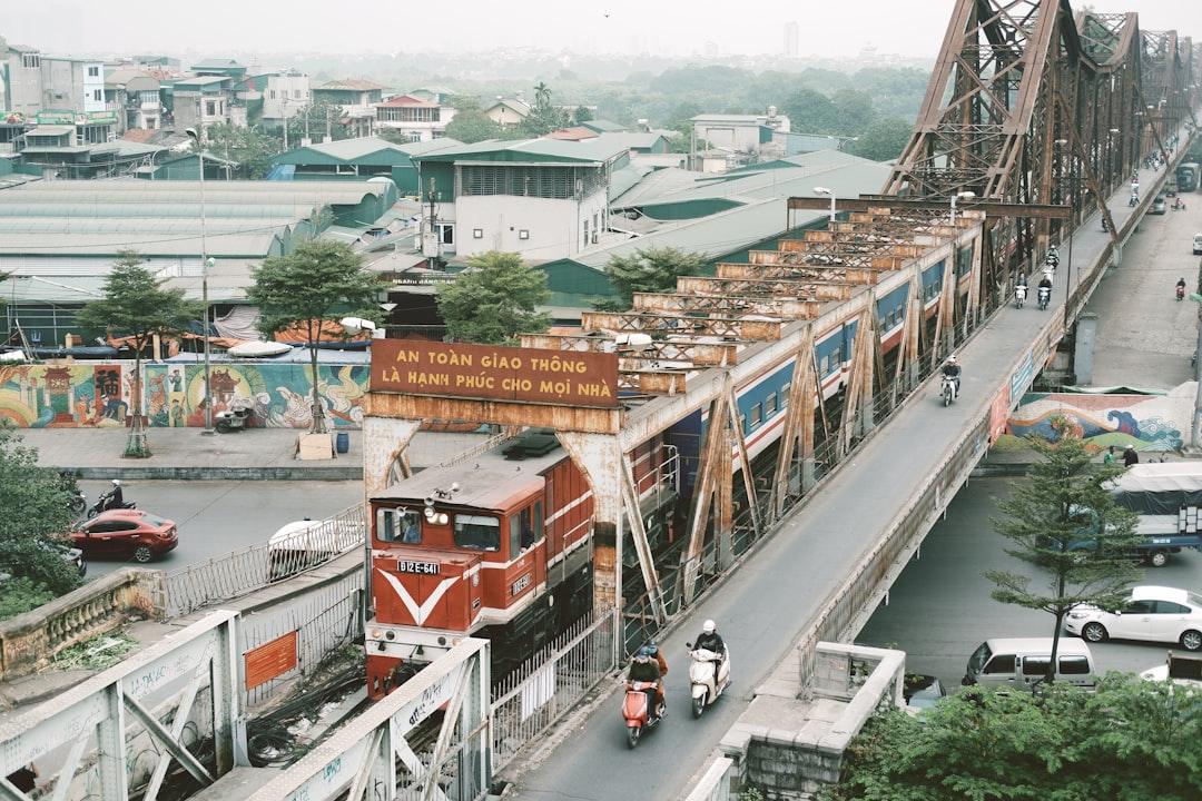 Red and white train on rail road during daytime from Long Bún on Unsplash