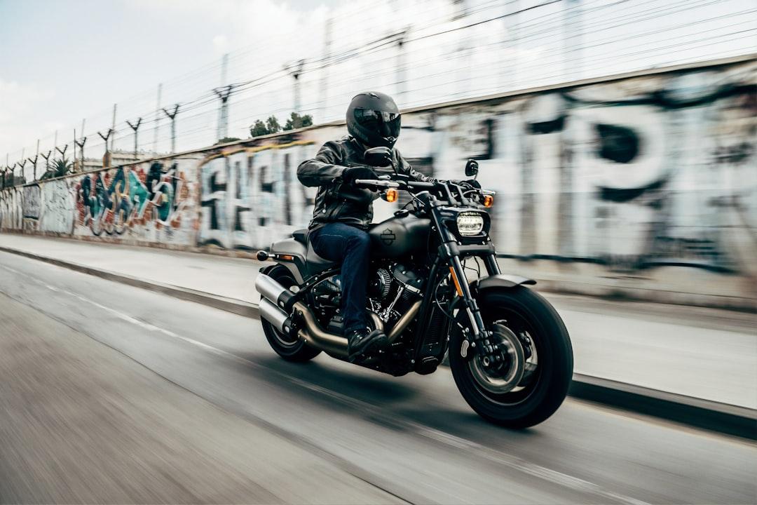 Person riding motorcycle on concrete road from Harley-Davidson on Unsplash
