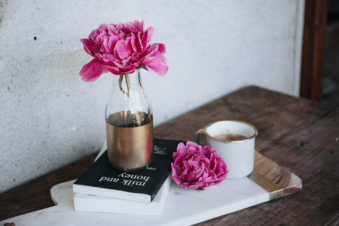 Pink petaled flower on bottle from Alisa Anton on Unsplash