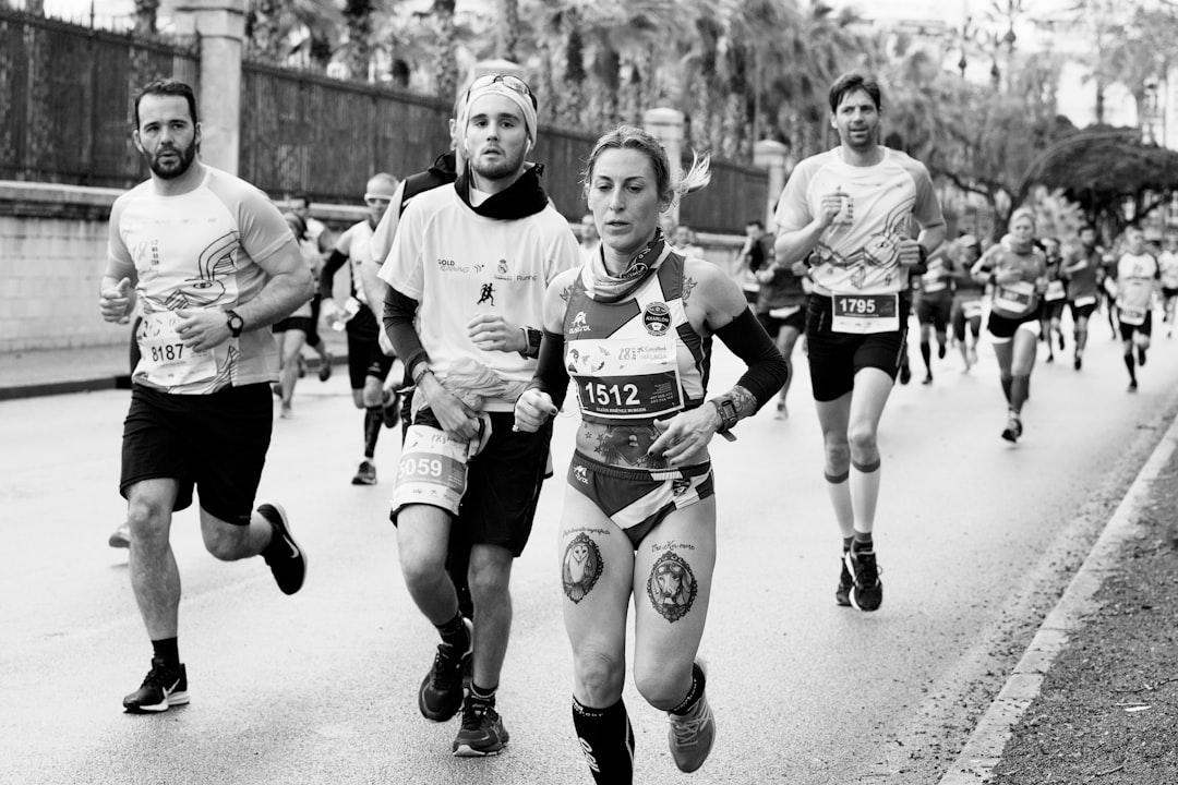 Grayscale photography of jogging people from Quino Al on Unsplash