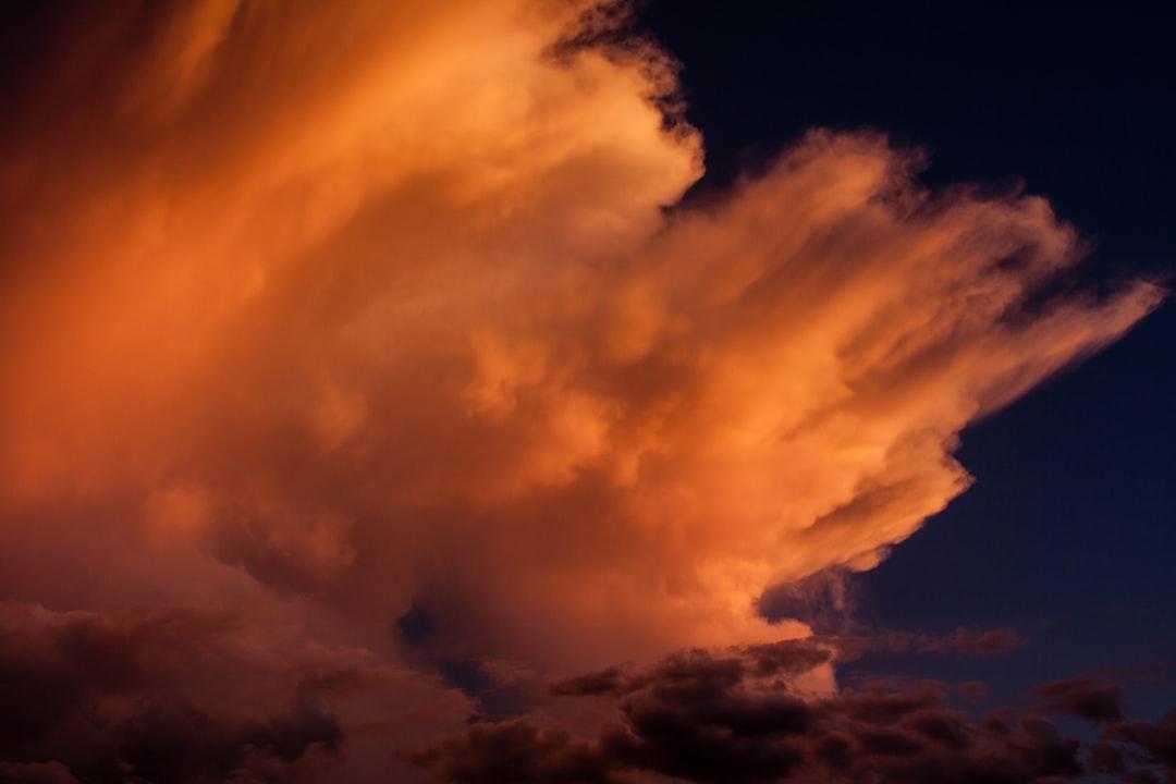 Wind blown cloud tops in the setting sun. from NOAA on Unsplash