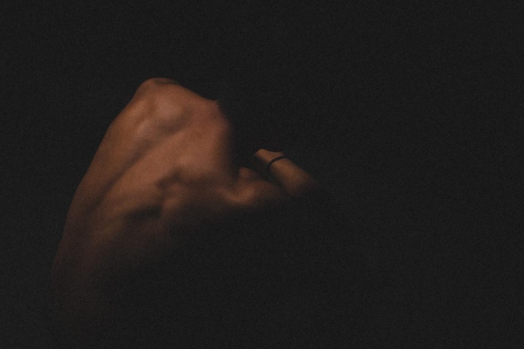 A hand holding a cell phone in the dark from Jason Schjerven on Unsplash