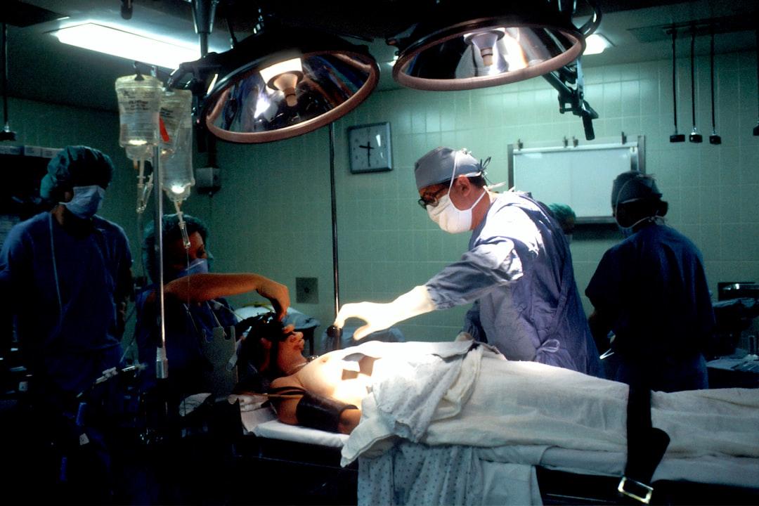 Doctor and nurses inside operating room from National Cancer Institute on Unsplash Vinamilk tư vấn chăm sóc sức khoẻ cho người cao tuổi