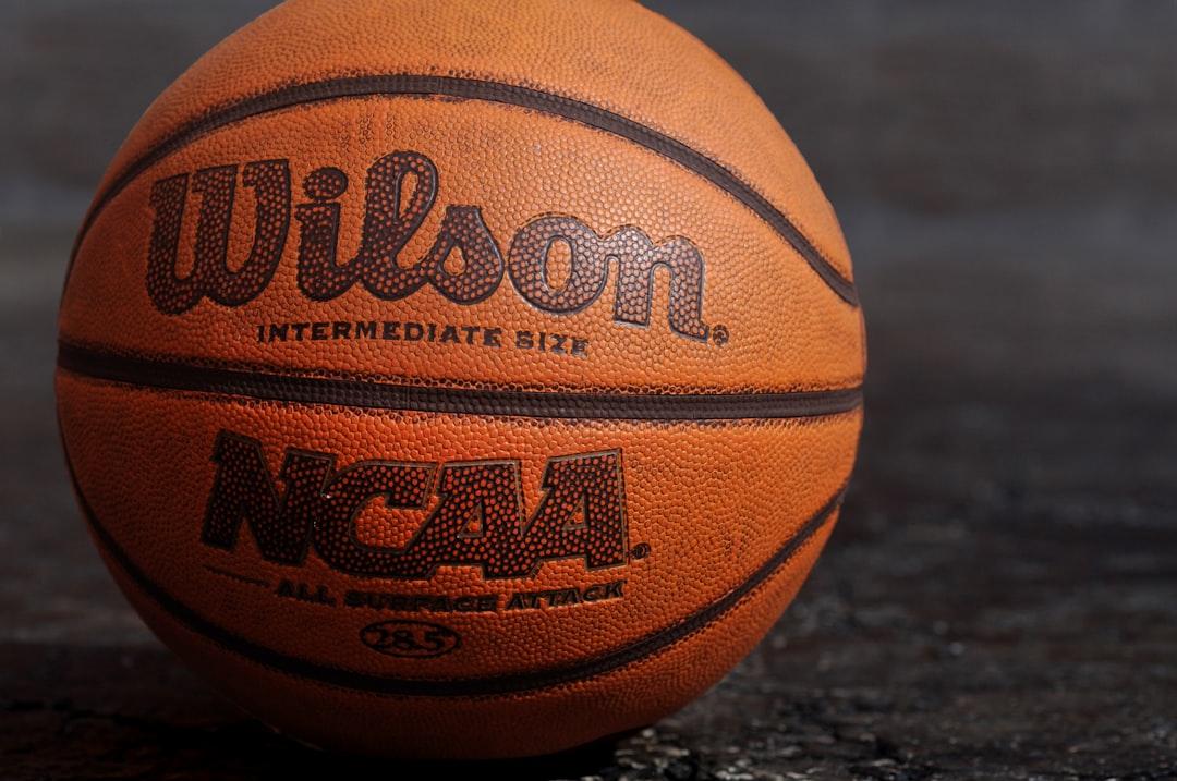 Wilson ncaa basketball on black board from Ben Hershey on Unsplash