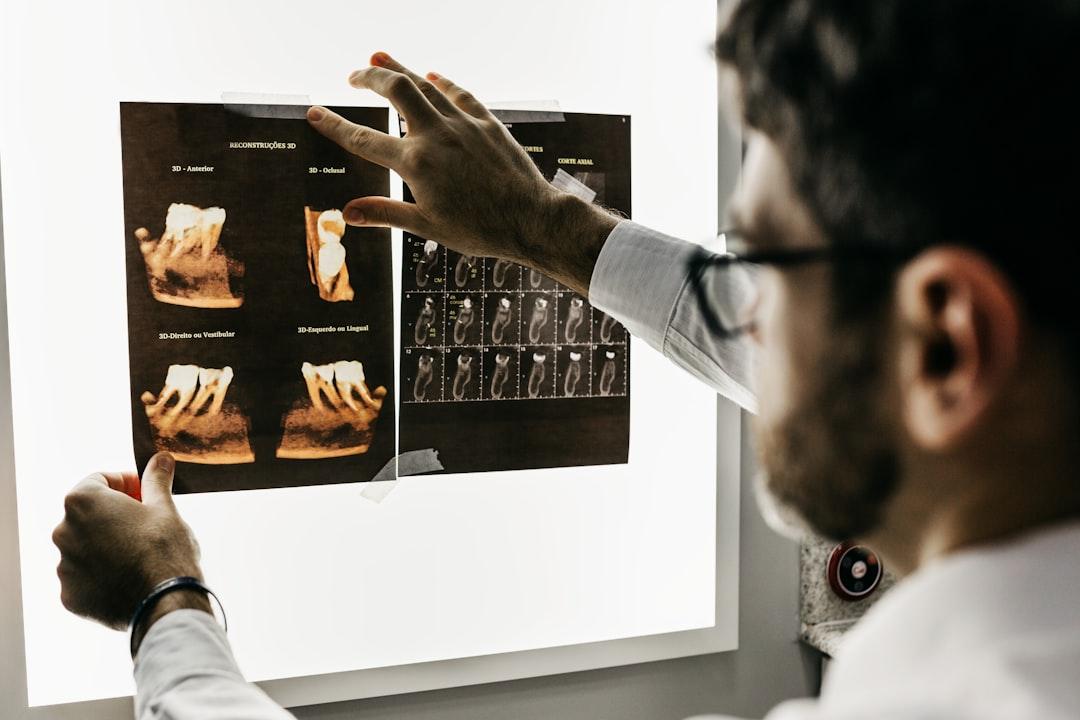 Person in gray long sleeve shirt holding black tablet computer from Jonathan Borba on Unsplash Bệnh sâu răng và các chất đường ngọt