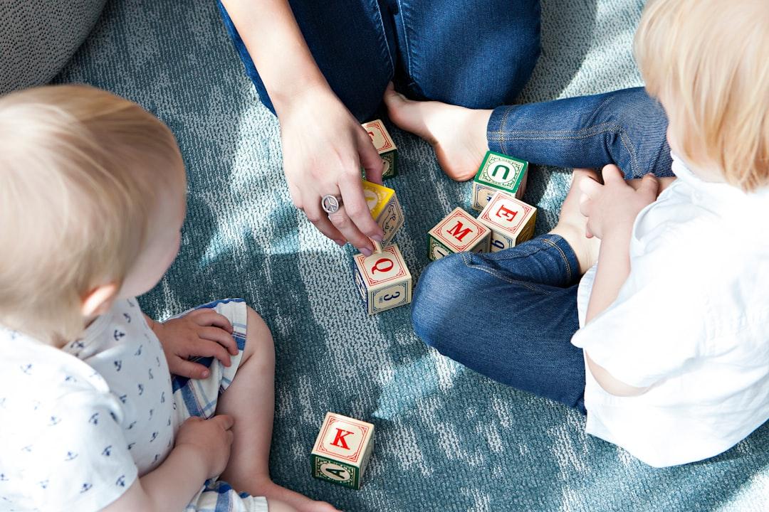 Two toddler playing letter cubes from Marisa Howenstine on Unsplash